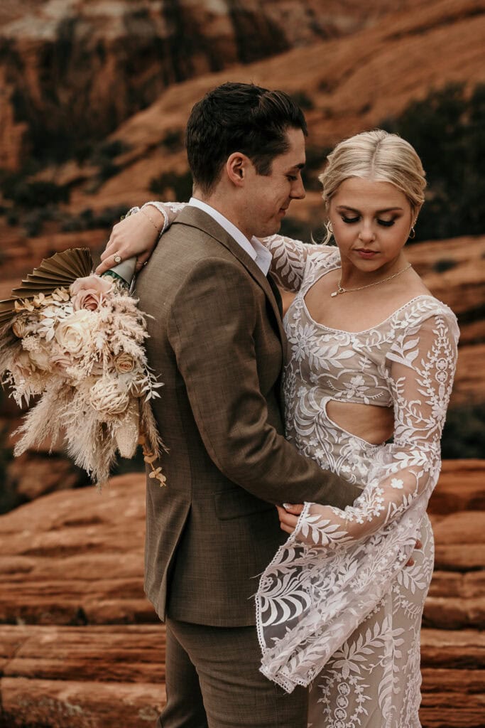 Skyler looks down while Jayson looks at her during their Utah wedding.