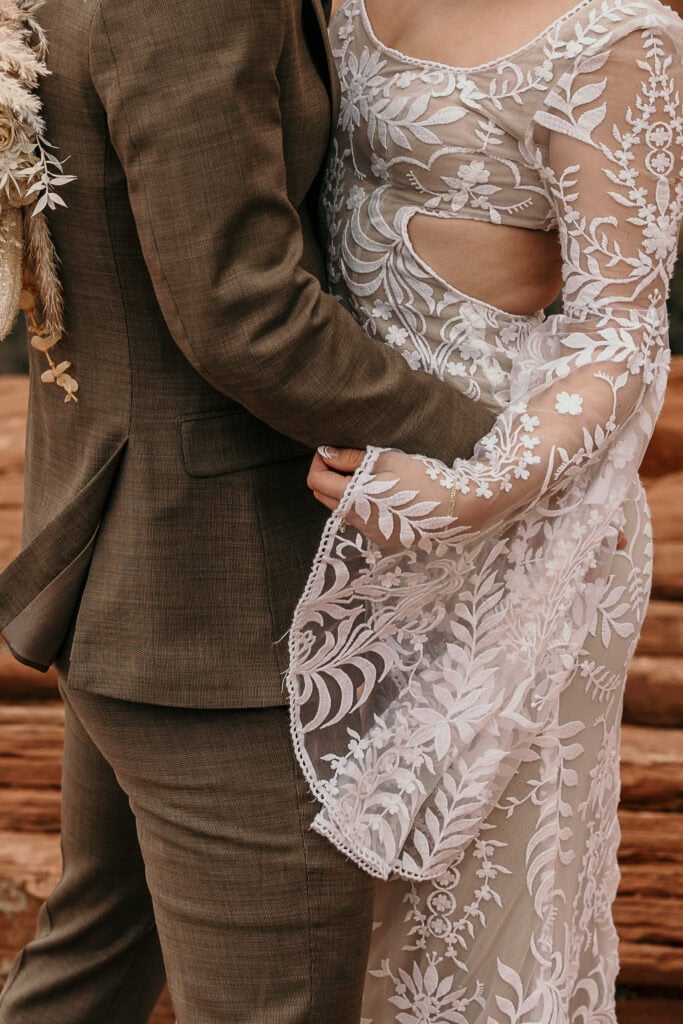 A closeup of the bride and groom's boho wedding attire.