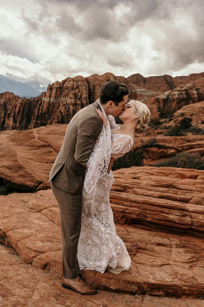 Boho bride and groom kiss during their elopement.