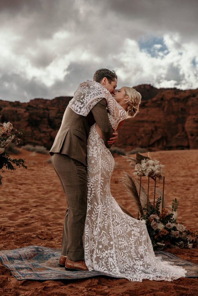 A couple embraces during their boho elopement in the desert.