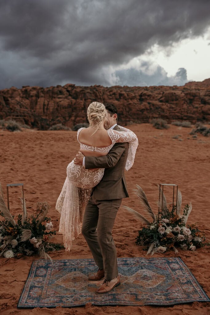 Groom playfully spins around with the bride in his arms.