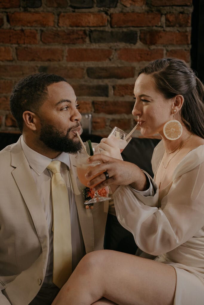 Couple drinks cocktails during elopement in Corsair Distillery in Nashville, Tennessee.