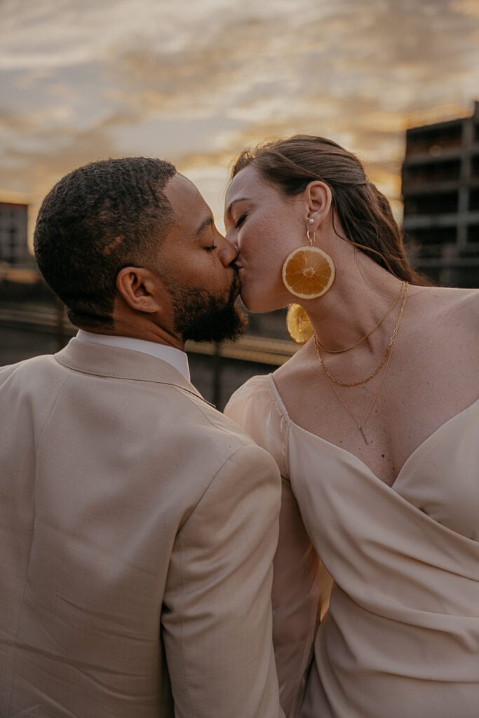 Eloped couple kisses in industrial area of Nashville during their elopement ceremony.