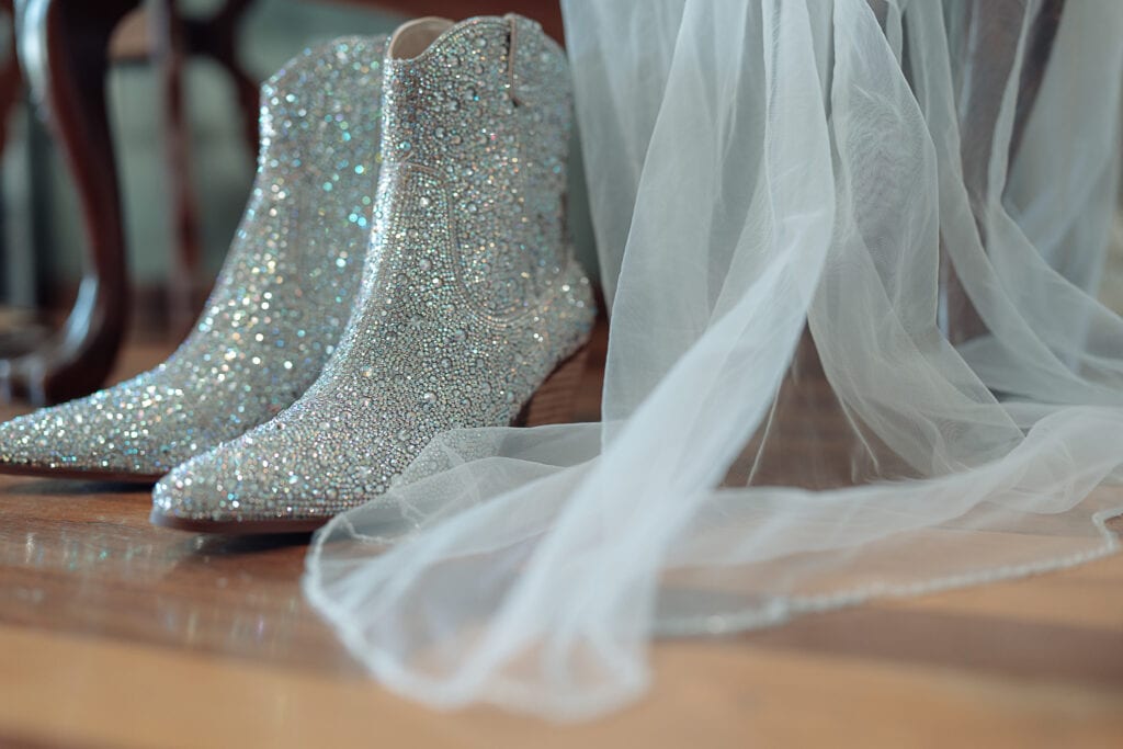 A bride's sparkling Betsy Johnson boots set nect to her veil.