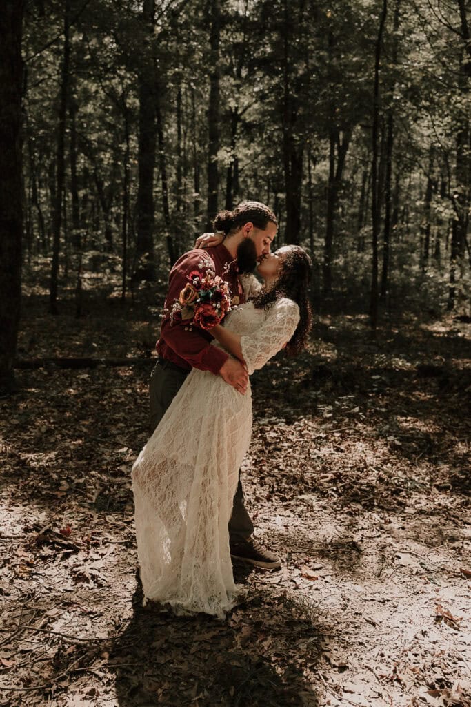 Couple has their first kiss during their outdoor wedding ceremony.