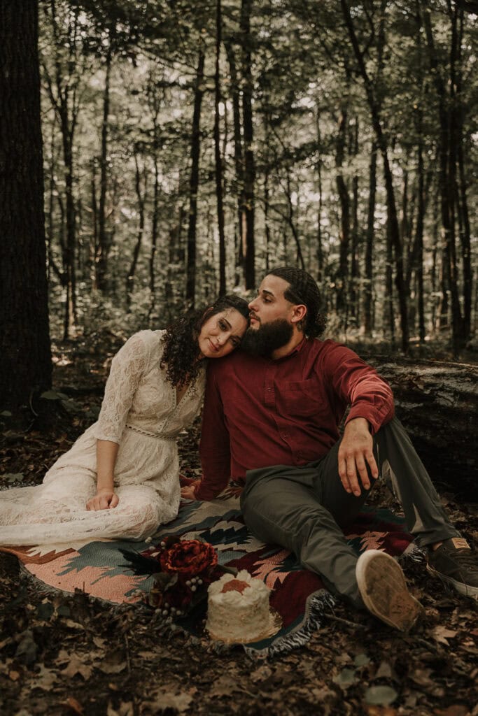 Mady & Ezekiel snuggle during their picnic on their elopement day.