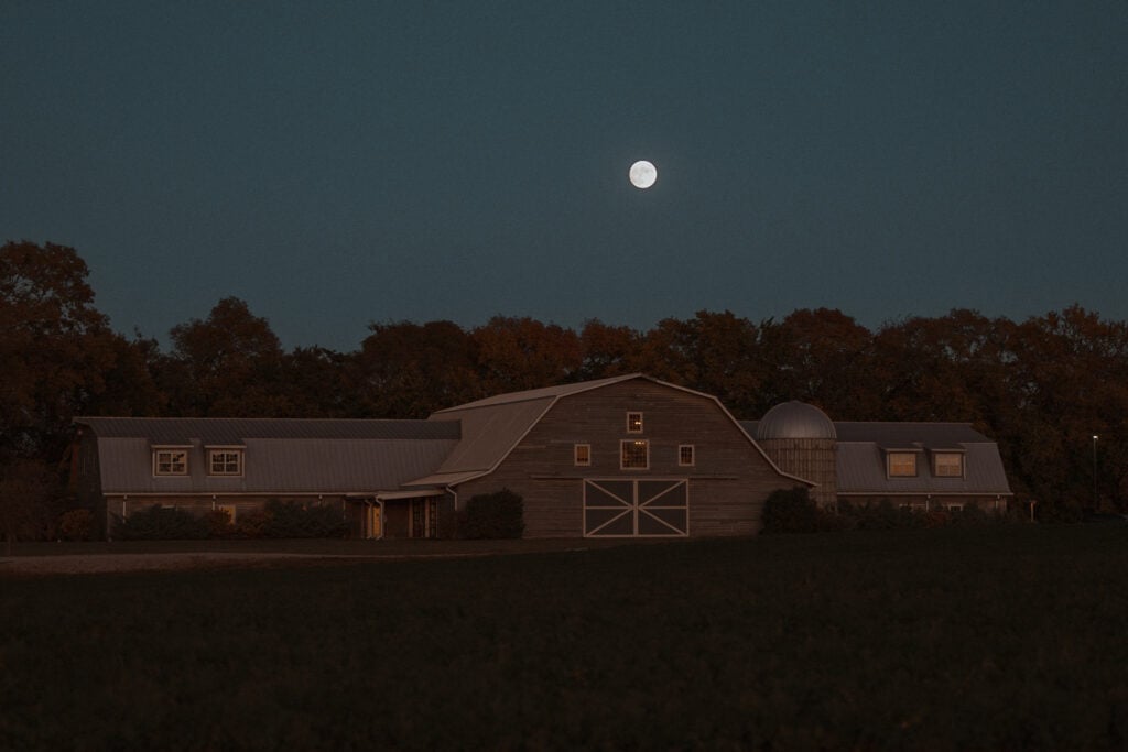 A full moon shines in a clear sky above The Silo Event Center.