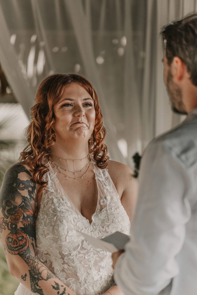 Bride gets emotional as the groom reads his vows to her.