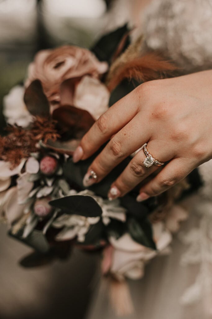 A bride's hand on her bouquet.