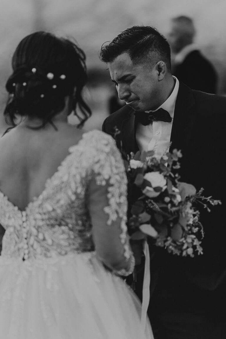 The bride's brother gets choked up with emotions at the site of his sister in a wedding gown.