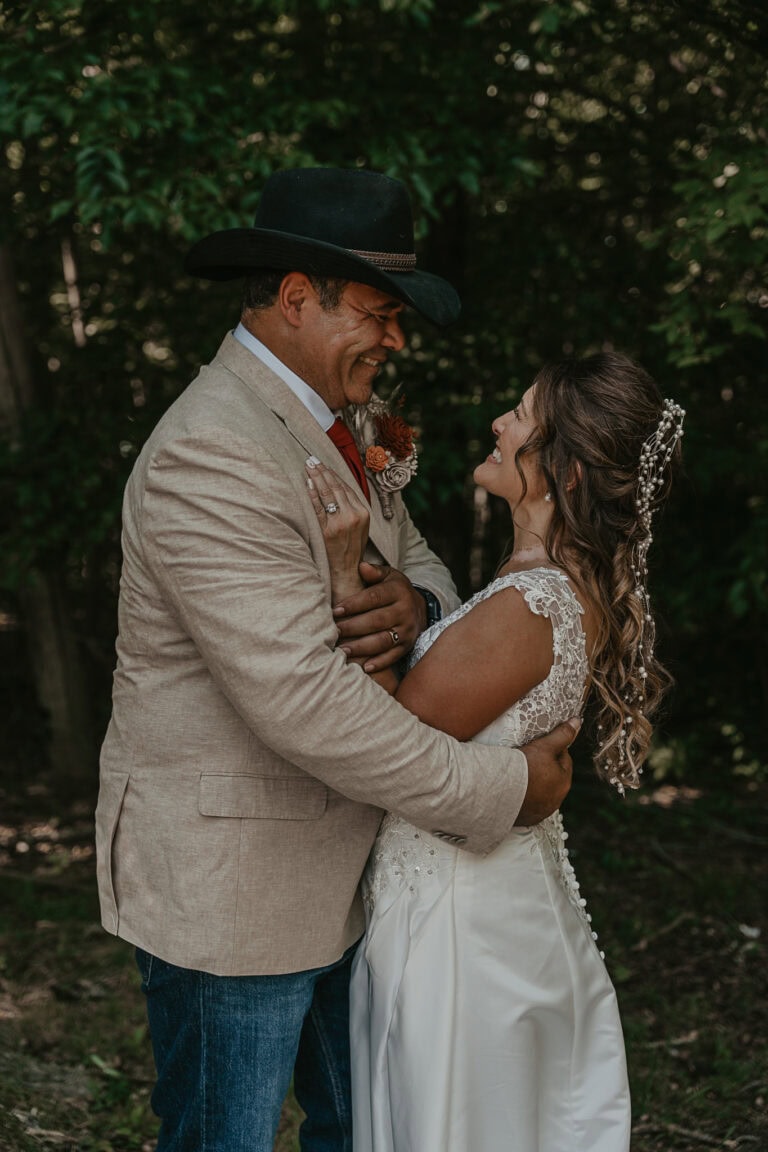 Bride and groom smile in delight at each other after their wedding ceremony.