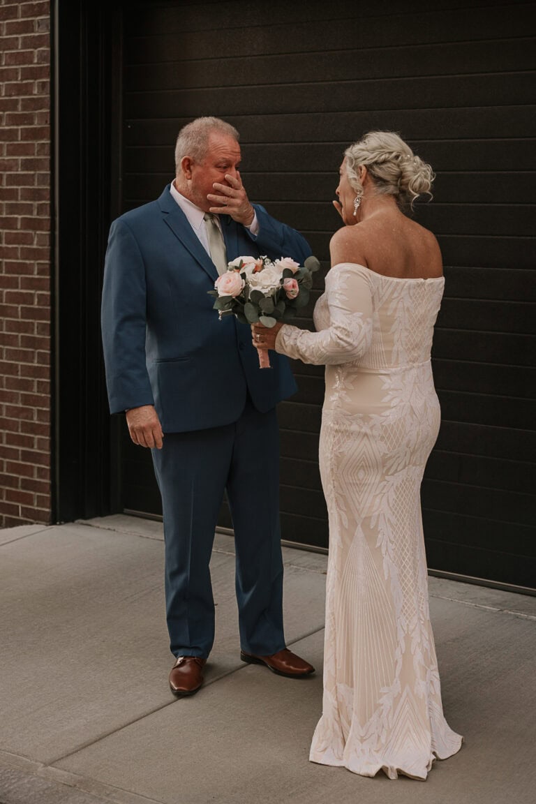 Groom gets emotional during a first look with the bride.