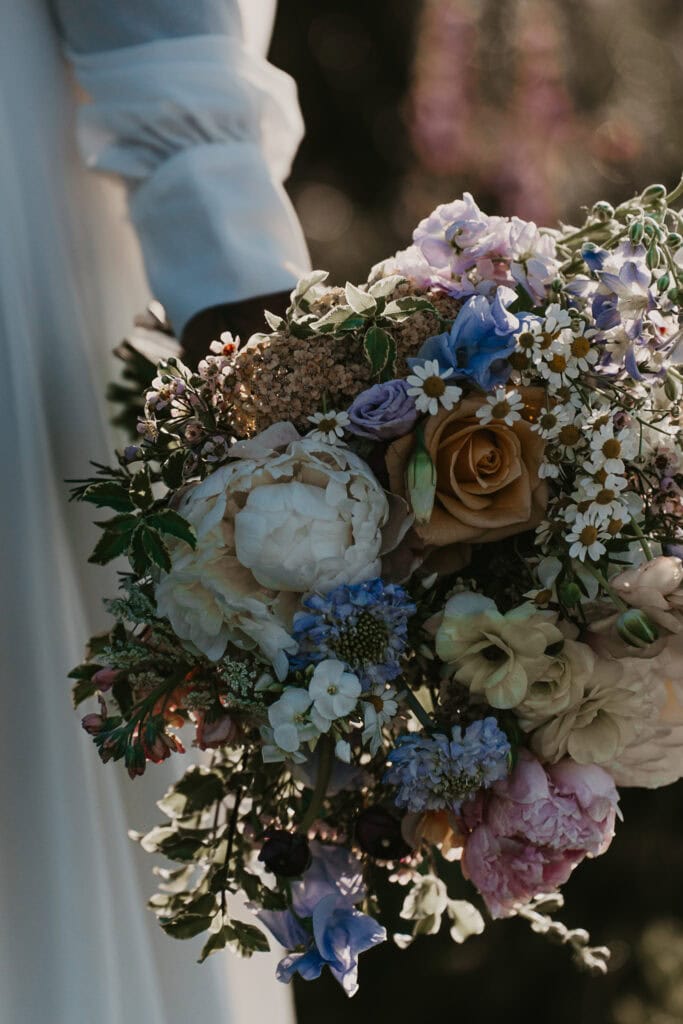 A closeup of a bride holding her wedding bouquet.