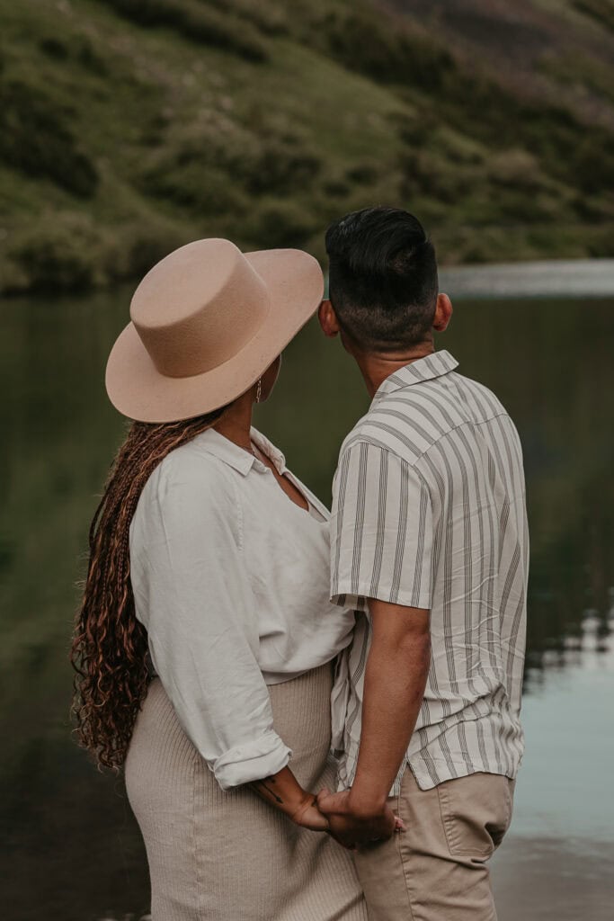 Marissa & Janiel look out over a lake on a clear summer day.