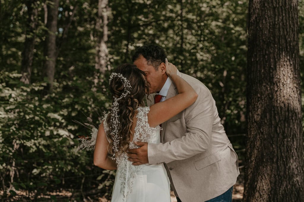 Bride and Groom kiss outside before their wedding ceremony.