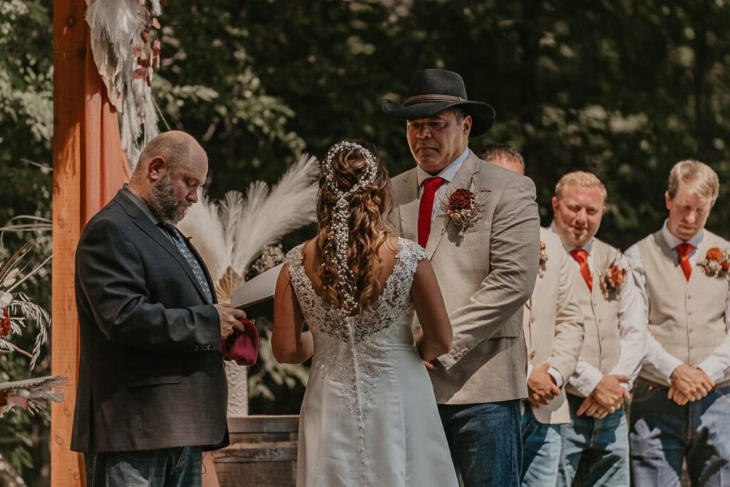 John recites his vows to Anita during their outdoor wedding.