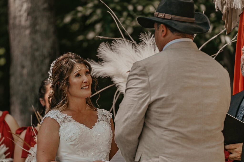 Anita looks up at John as she recites her vows to him during their wedding in their backyard.