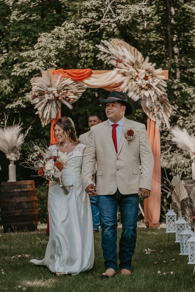 John and Anita walk back down the aisle together after being pronounced husband and wife.