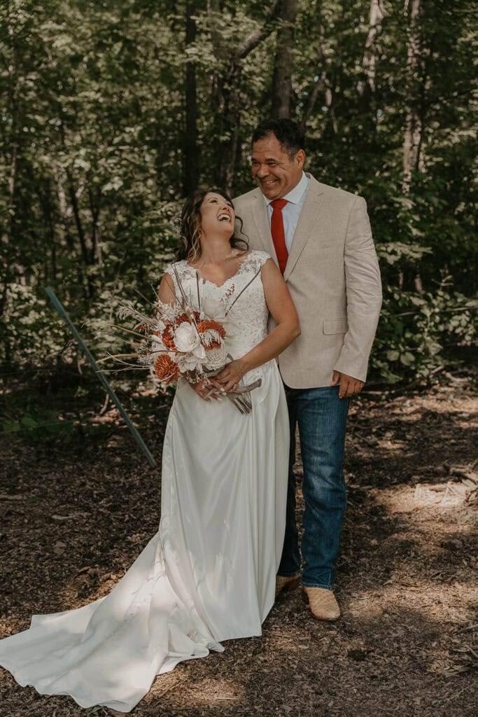 John and Anita laugh together during their wedding portraits.