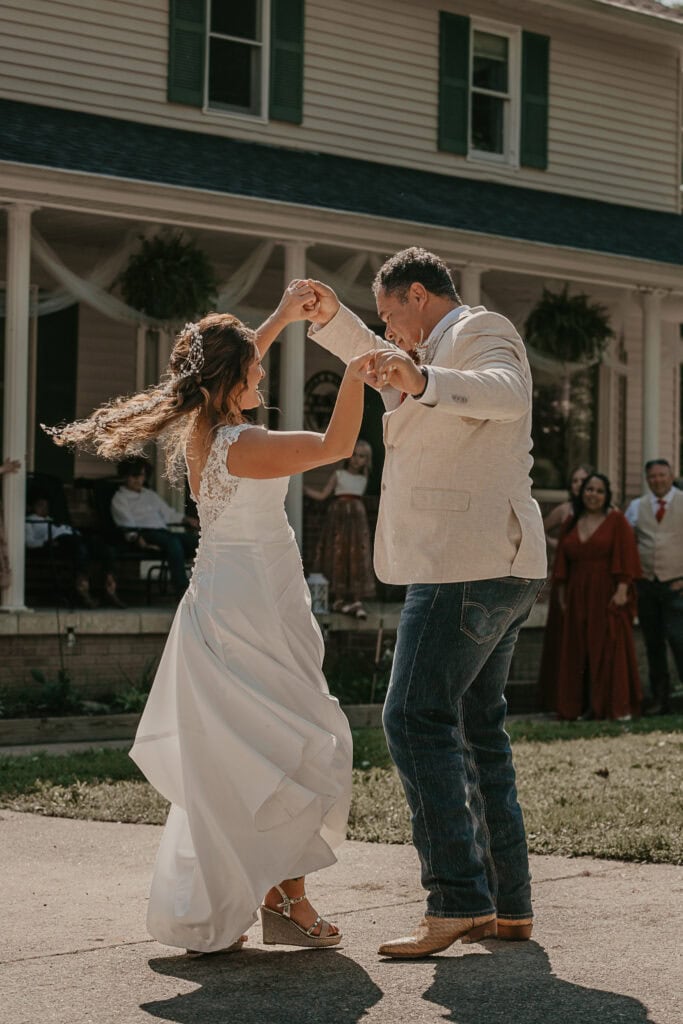 Bride and Groom dance in their front yard during their outdoor wedding.