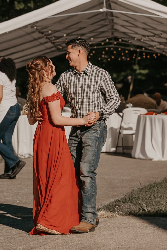 A couple dances at an outdoor wedding.