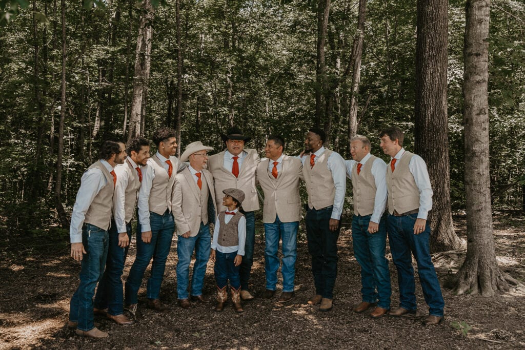 Groomsmen pose with the groom on his wedding day.