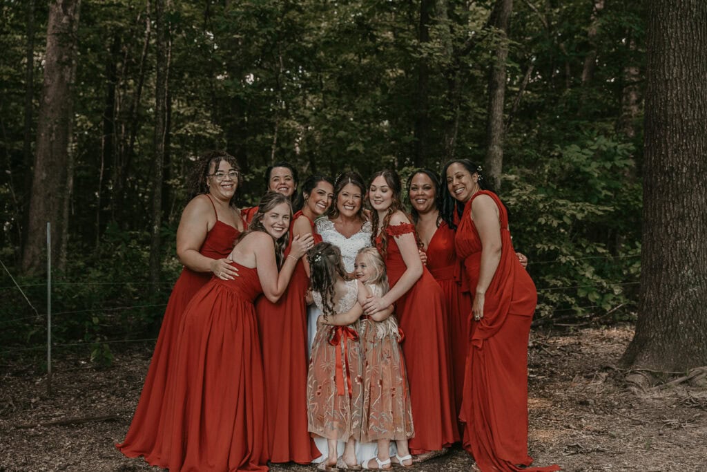 Bridesmaid's hug the bride on her wedding day.