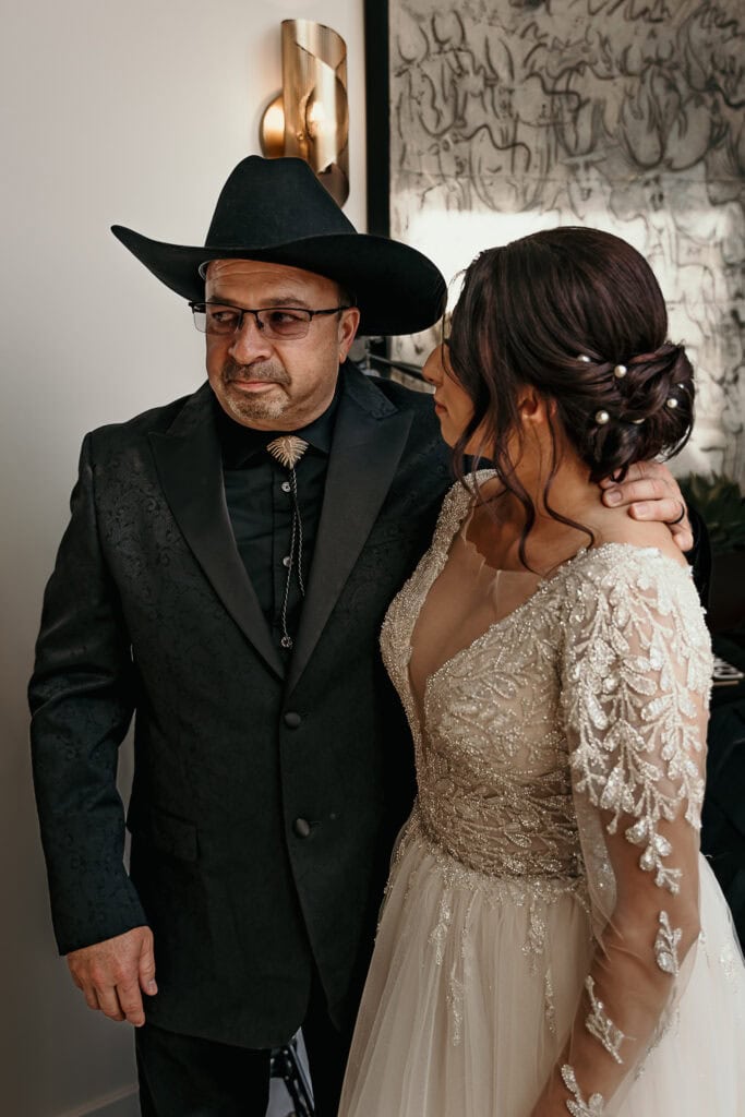 A bride looks at her emotional dad after he's seen her for the first time on her wedding day.