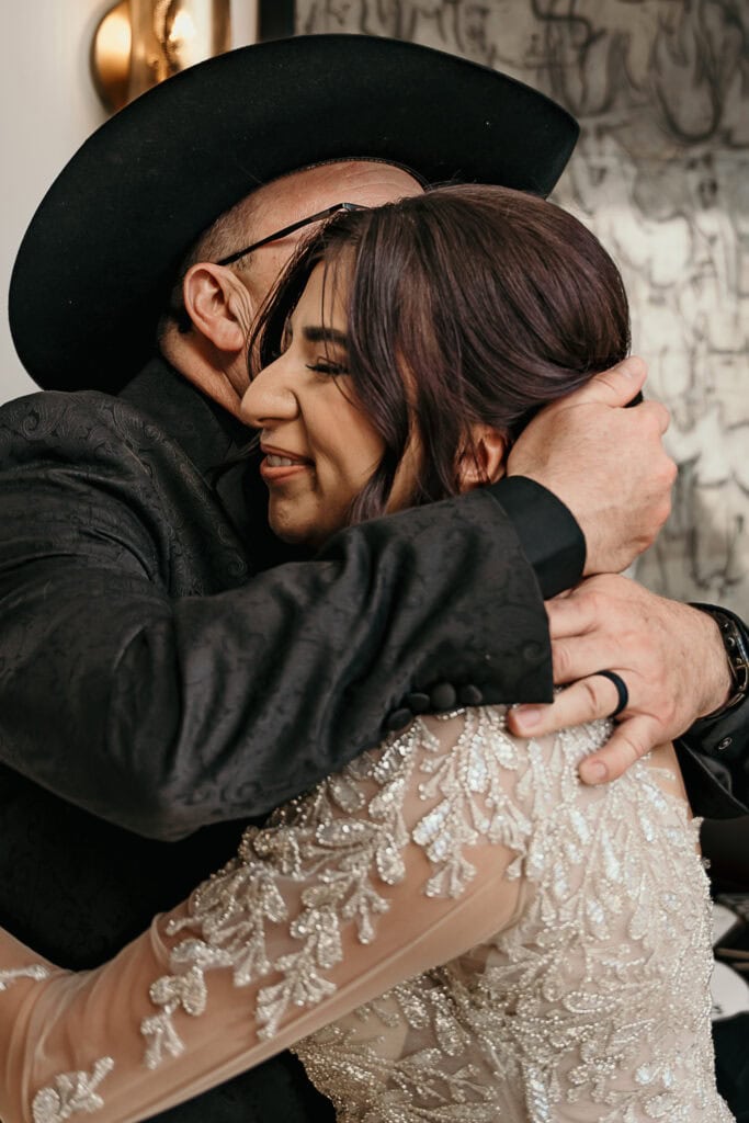 Amaris and her dad hug after he's seen her in her wedding dress for the first time.