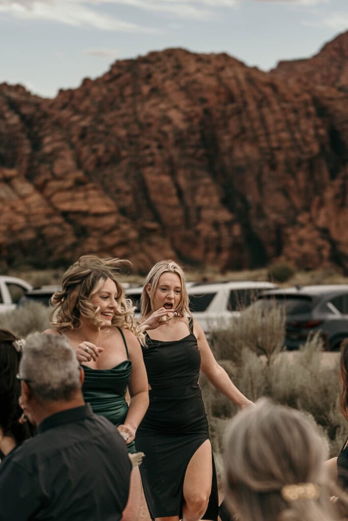 A pair of shot girls throw alcohol at an outdoor wedding.