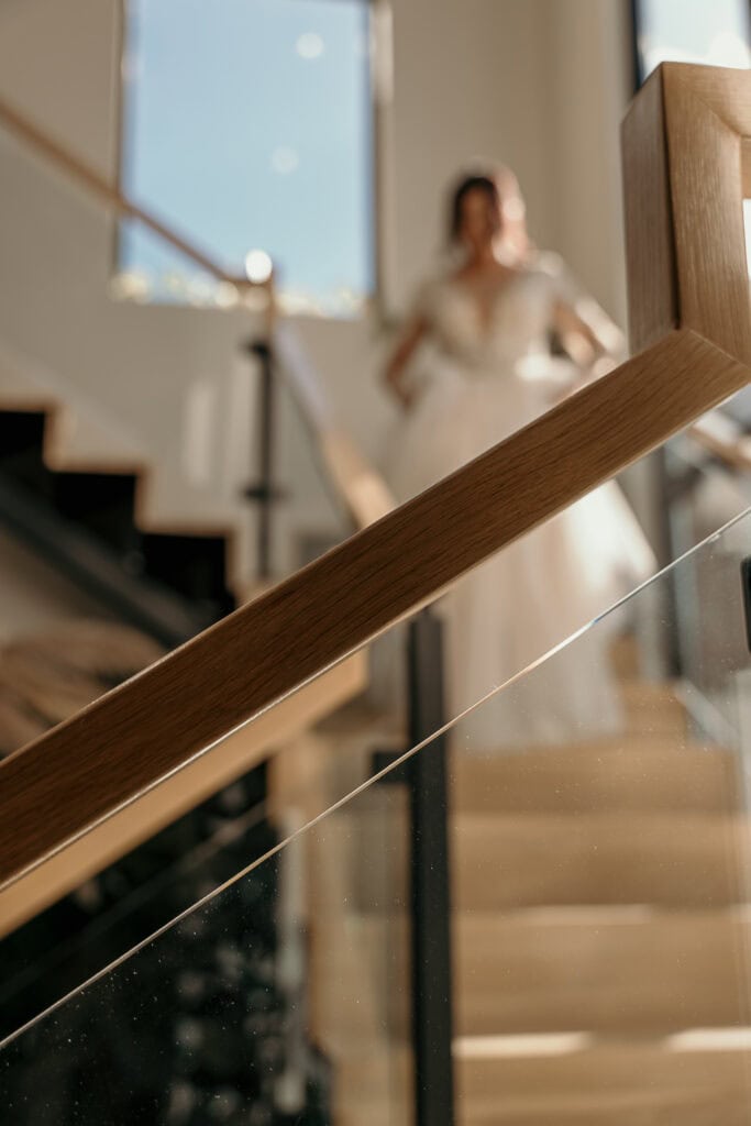 A blurry photo of a bride walking down the stairs.