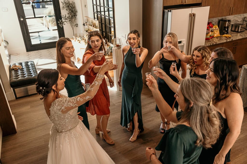 A bride and her friends toast together before the wedding ceremony.