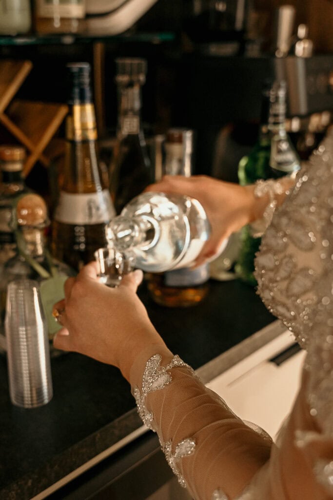 Amaris pours shots for her friends on her wedding day.