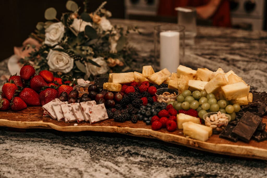 A colorful charcuterie board on a marble counter.