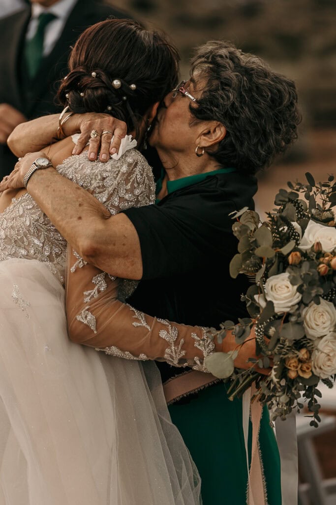 Amaris' grandma hugs her and kisses her cheek after her wedding.