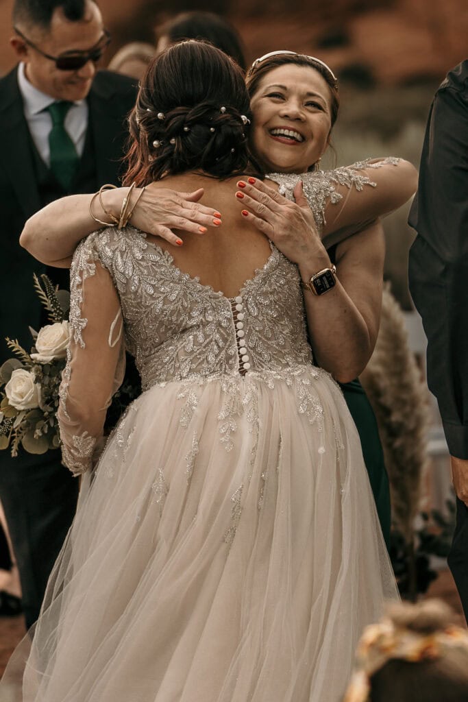 Amaris and a friend hug after her wedding.