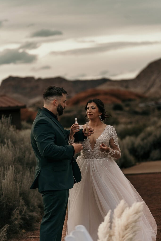 A bride and groom do shots right after their wedding ceremony.