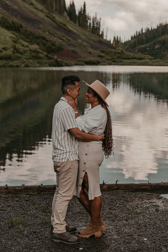 a loving couple being sweet with each other at emerald lake shore