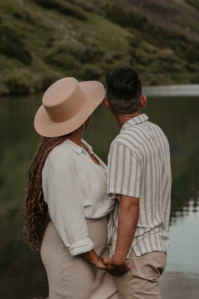 cute couple being gazing upon Emerald Lake in Crested Butte