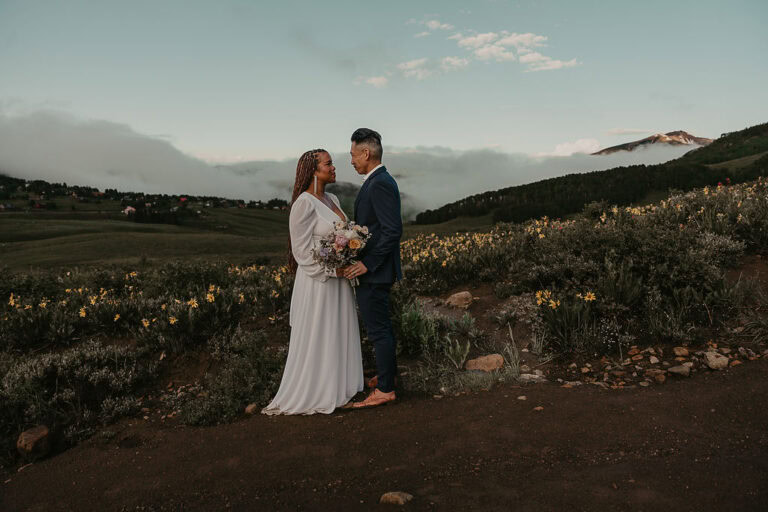 a dreamy elopement couple in a wildflower field for their crested butte elopement