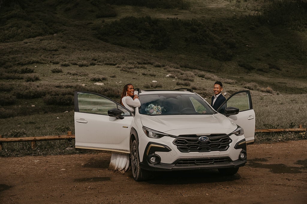 elopement couple posing with their jeep