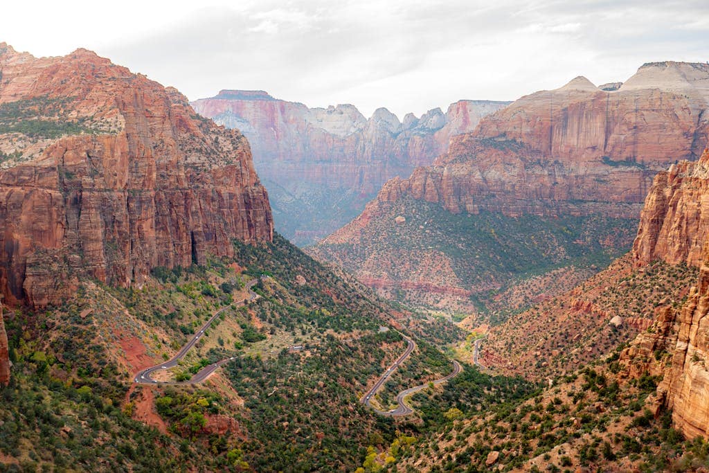 Stunning aerial view of the winding road through Zion National Park's majestic canyon landscape.