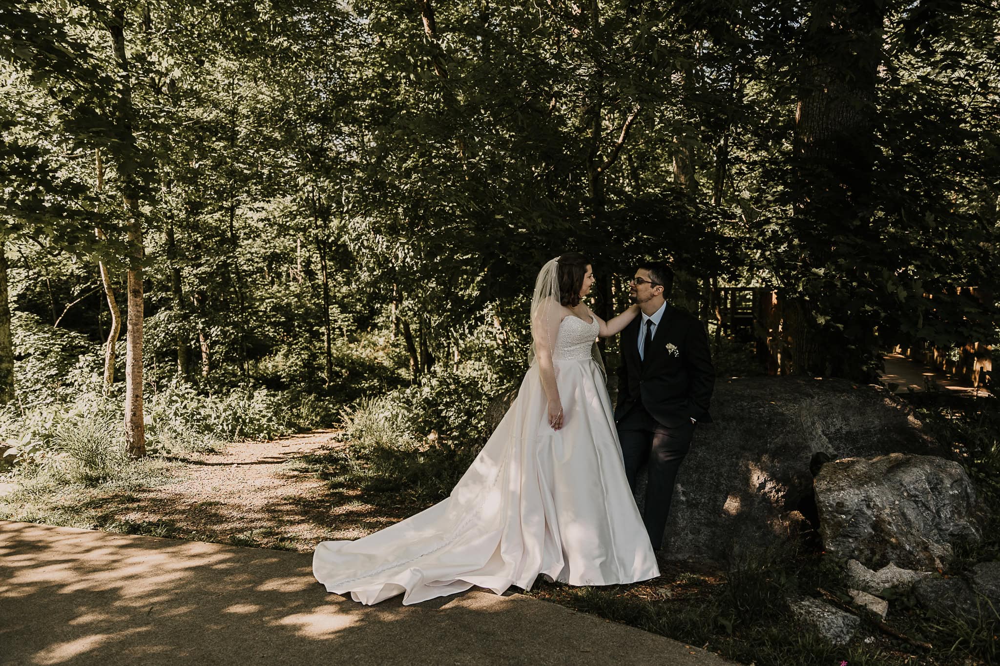 A couple takes a moment in the shade with each other before their outdoor wedding.